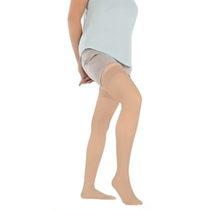 Beige thigh-high compression stockings worn on a person's leg to promote circulation and leg health.