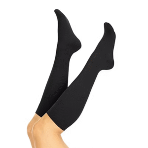 Pair of black knee-high compression socks worn on legs to improve circulation and reduce swelling.