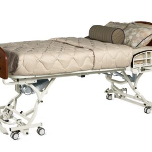 Full electric hospital bed with dark cherry wood panels, tan quilted bedding, and integrated side safety rail.