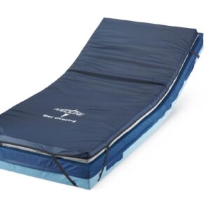 Medline gel mattress overlay with navy blue waterproof cover secured to a hospital bed mattress with elastic straps.