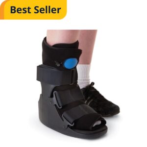 Black orthopedic walking boot with adjustable straps and blue air pump button for ankle injury recovery.